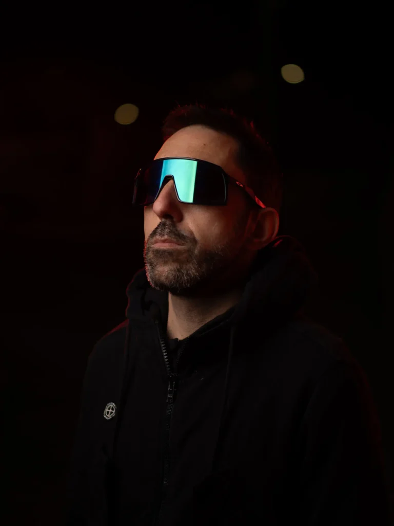 Retrato masculino con gafas de visor sobre fondo oscuro